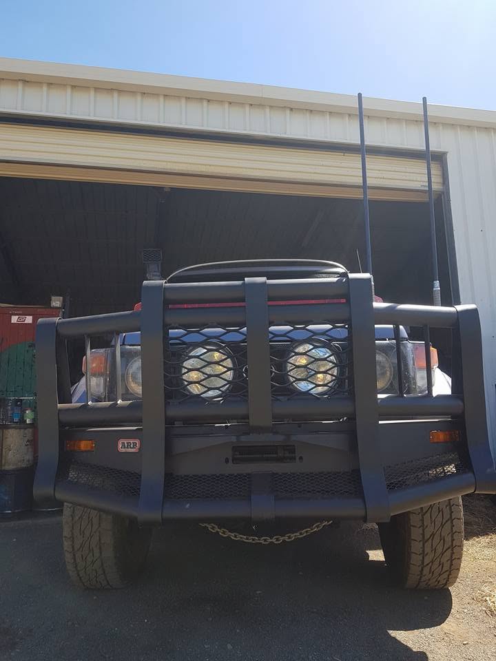 Steel bull bar with mesh-protected driving lights on a work 4WD