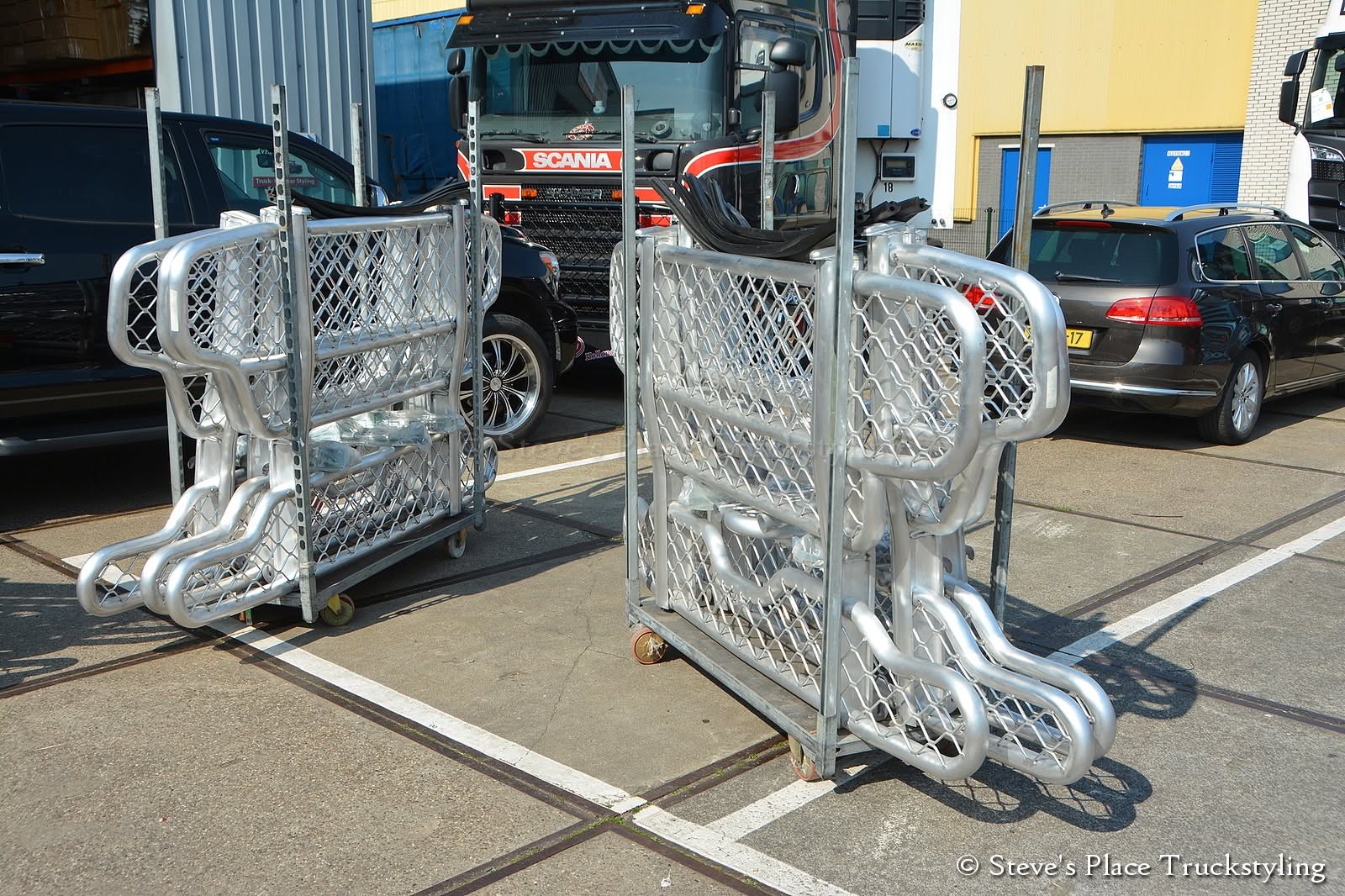 Freshly fabricated alloy bull bars racked and ready for finishing